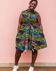 The model is wearing black dress with purple , yellow and turquoise dotted fans