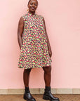 The model is wearing multi-colored scallop tiles print dress