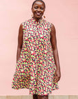 The model is wearing multi-colored scallop tiles print dress