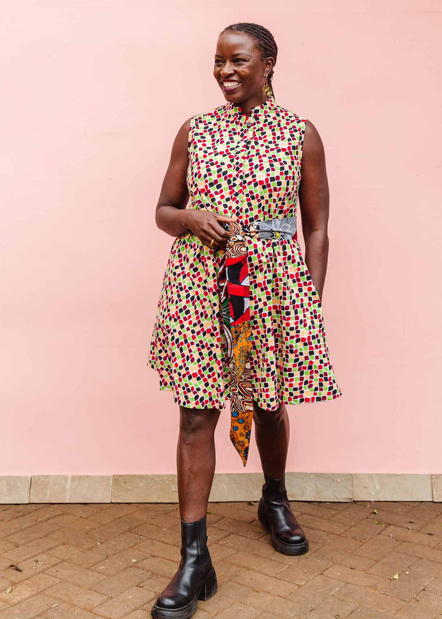 The model is wearing multi-colored scallop tiles print dress