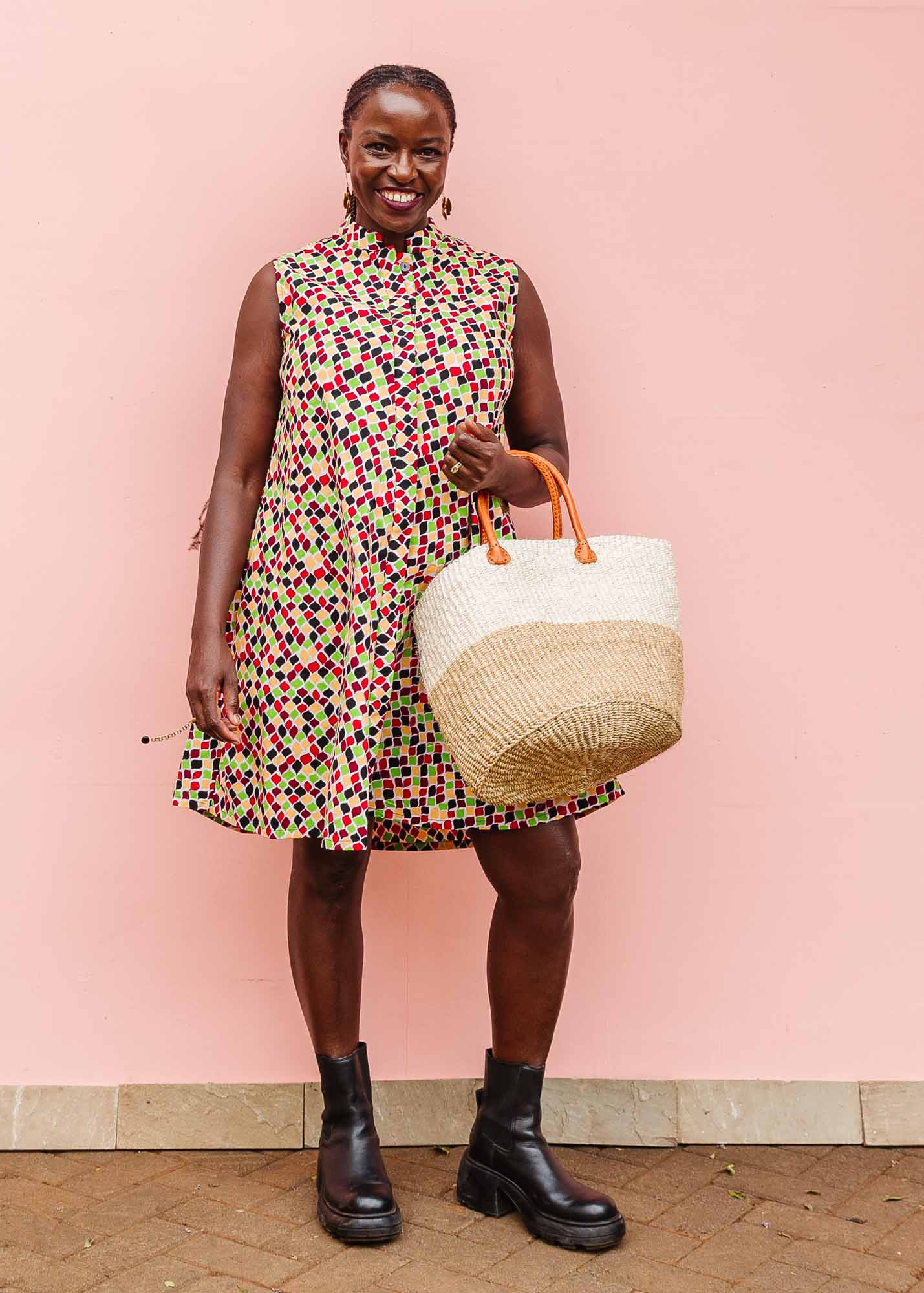 The model is wearing multi-colored scallop tiles print dress