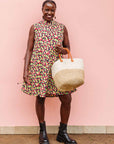 The model is wearing multi-colored scallop tiles print dress