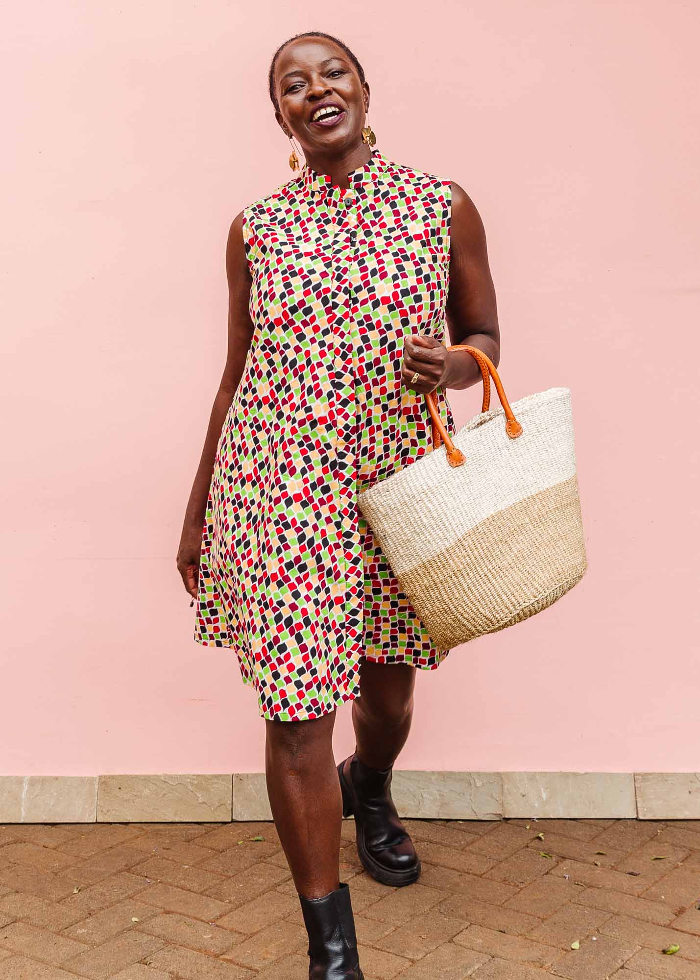 The model is wearing multi-colored scallop tiles print dress