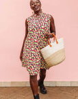The model is wearing multi-colored scallop tiles print dress
