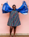The model is wearing pink, blue, turquoise and beige abstract line dress.