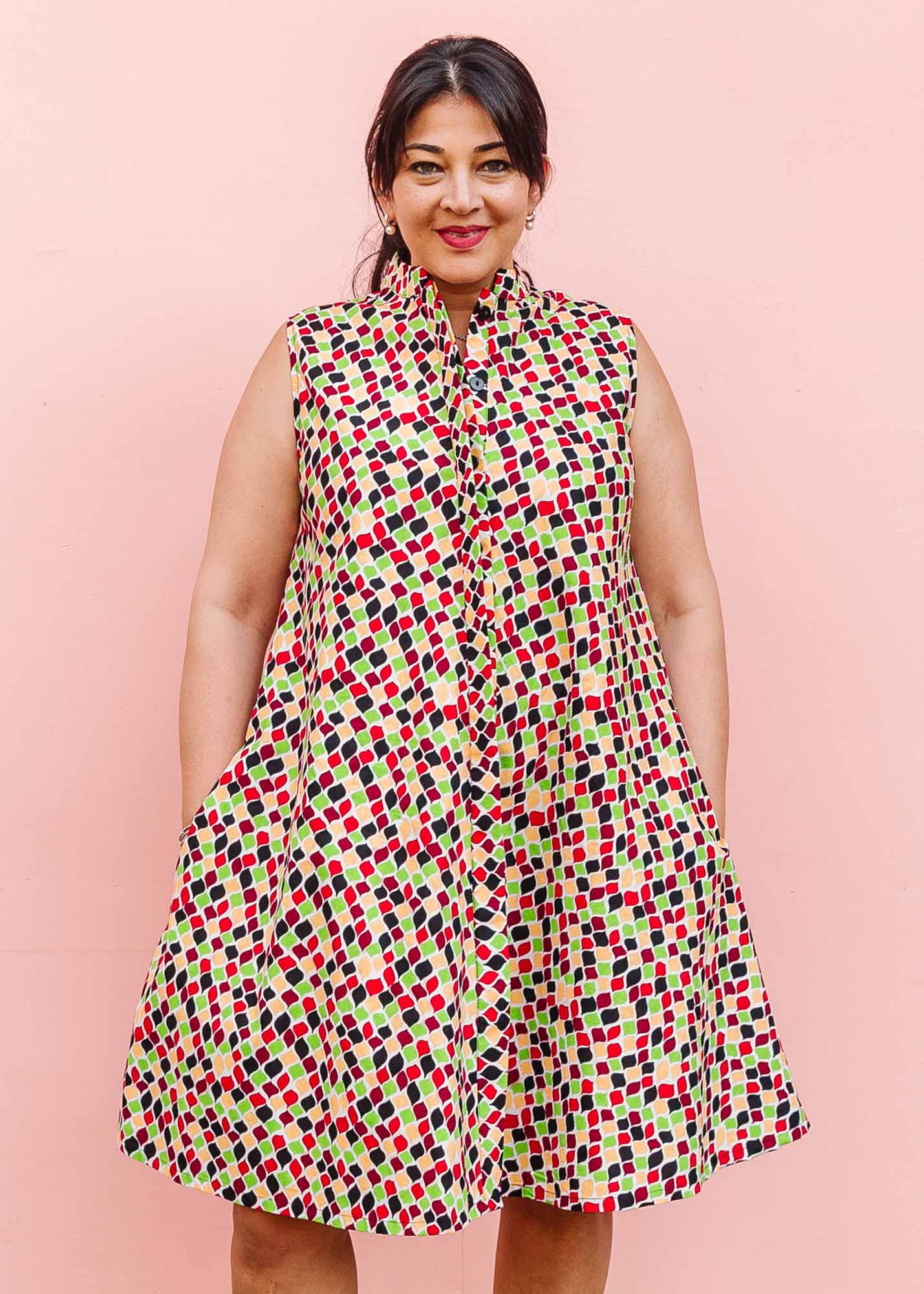 The model is wearing multi-colored scallop tiles print dress