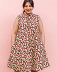 The model is wearing multi-colored scallop tiles print dress