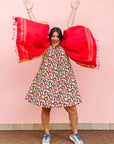 The model is wearing multi-colored scallop tiles print dress