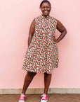 The model is wearing multi-colored scallop tiles print dress