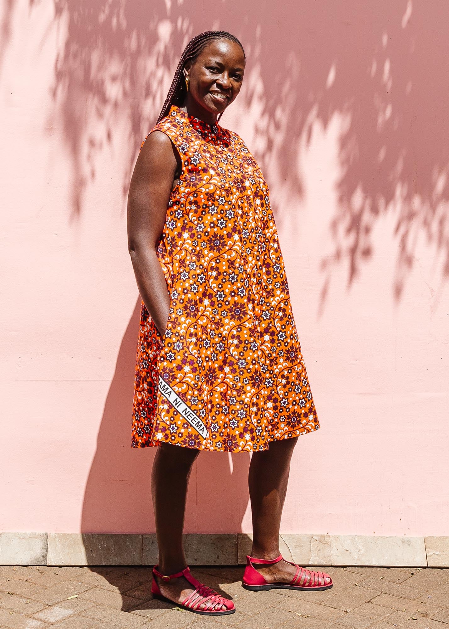 The model is wearing multi-colored floral print dress