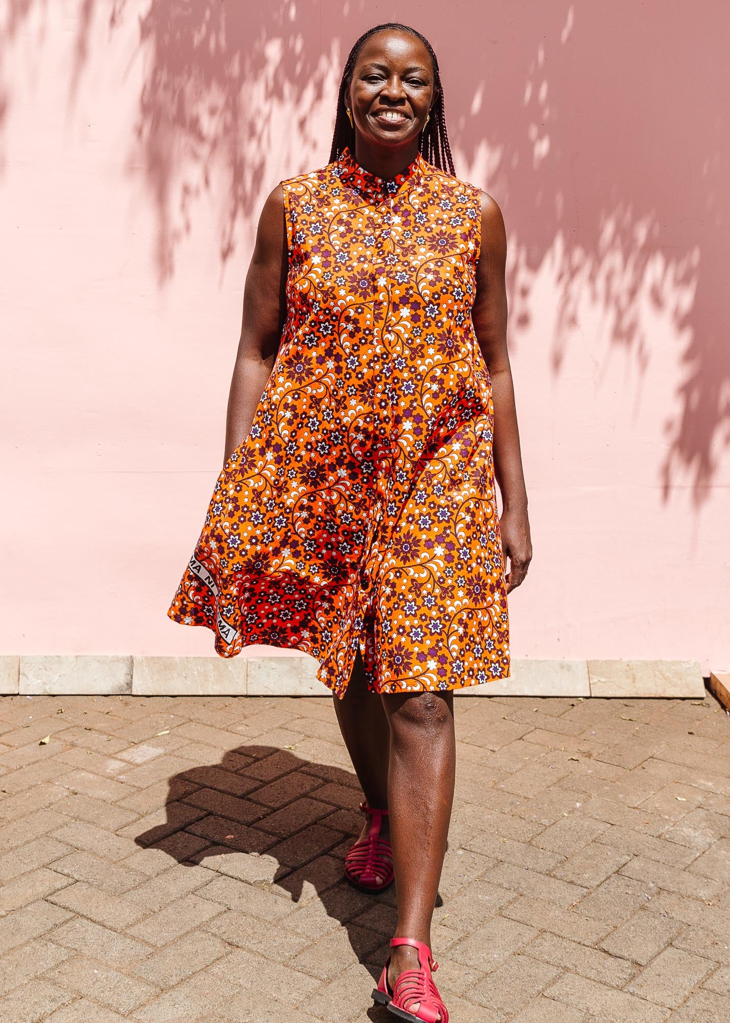 The model is wearing multi-colored floral print dress