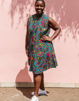 The model is wearing black, yellow, blue, red, pink print dress