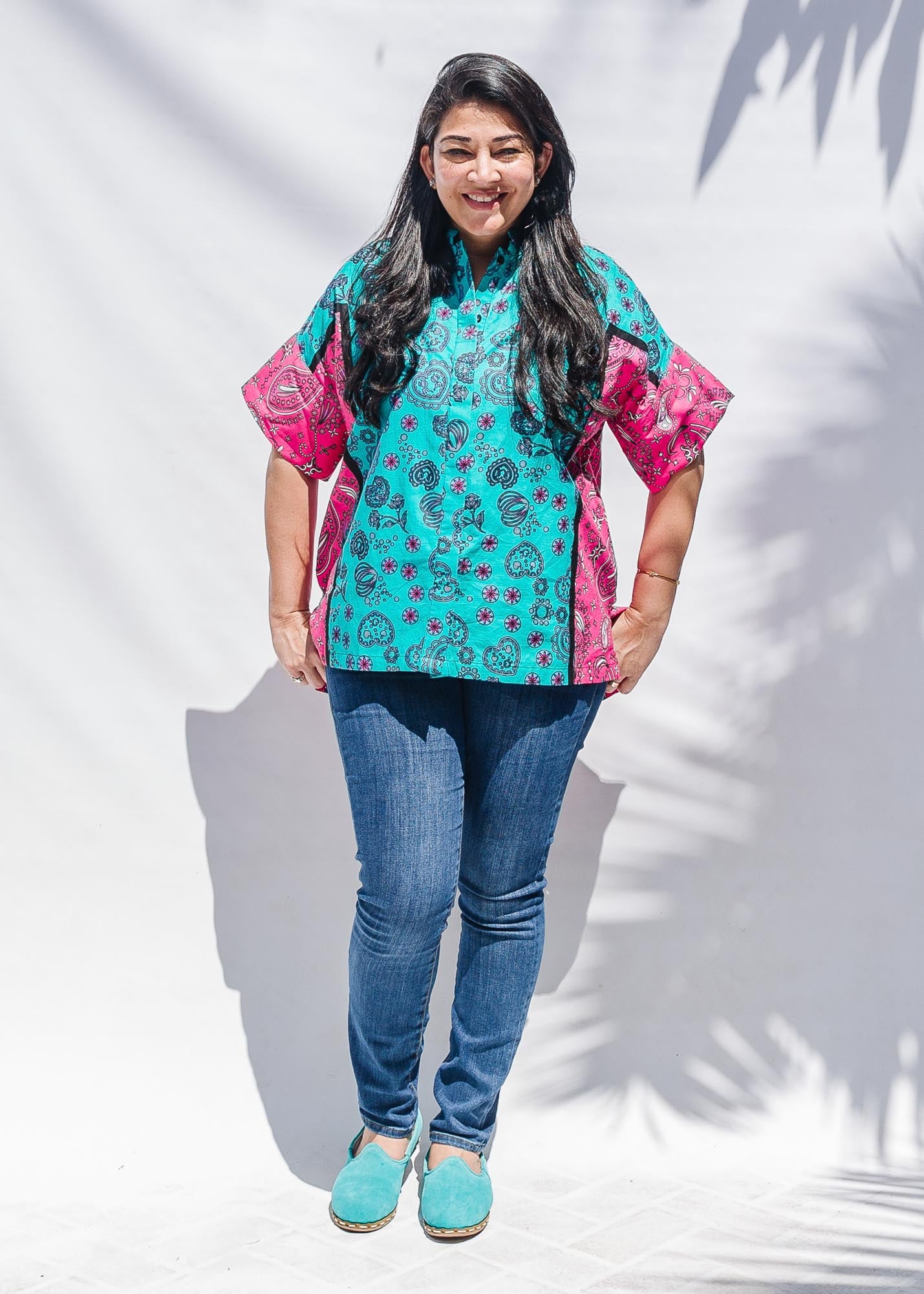 The model is wearing black, pink, sky blue, white, purple print shirt