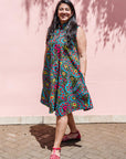 The model is wearing black, yellow, blue, red, pink print dress