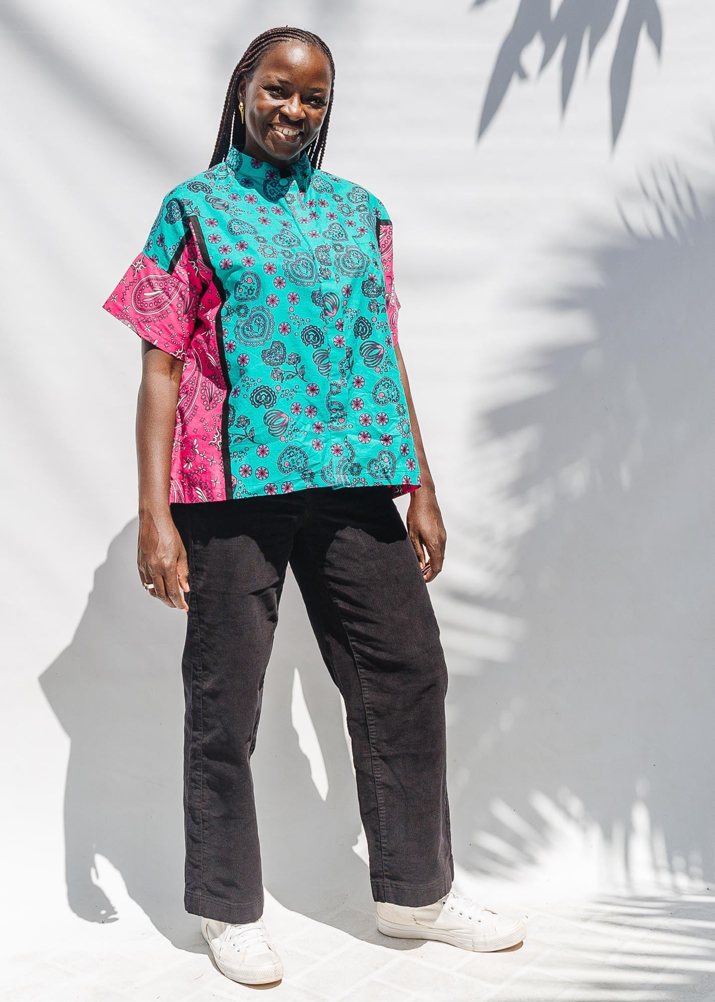 The model is wearing black, pink, sky blue, white, purple print shirt