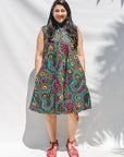 The model is wearing black, yellow, blue, red, pink print dress