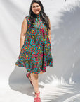 The model is wearing black, yellow, blue, red, pink print dress