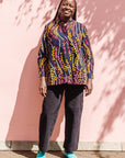 The model is wearing navy, yellow, white, red print shirt