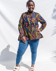 The model is wearing navy, yellow, white, red print shirt