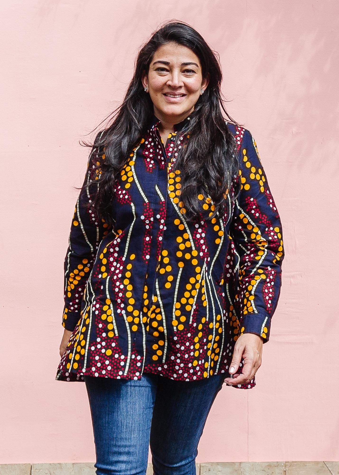 The model is wearing navy, yellow, white, red print shirt