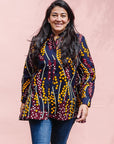The model is wearing navy, yellow, white, red print shirt