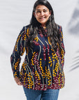 The model is wearing navy, yellow, white, red print shirt