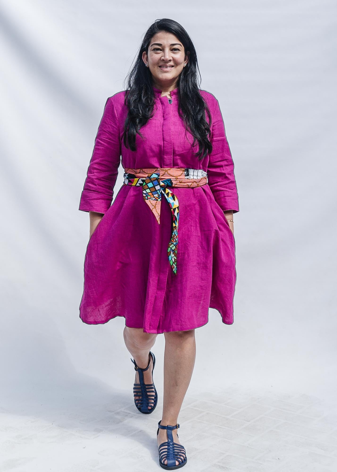 The model is wearing fuchsia dress