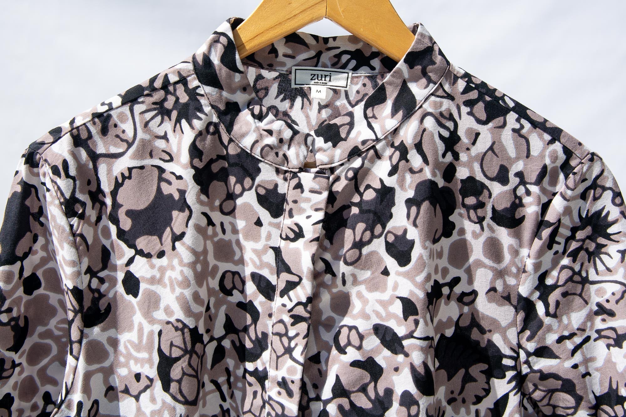Display of black, off white, gray and dark gray abstract print dress