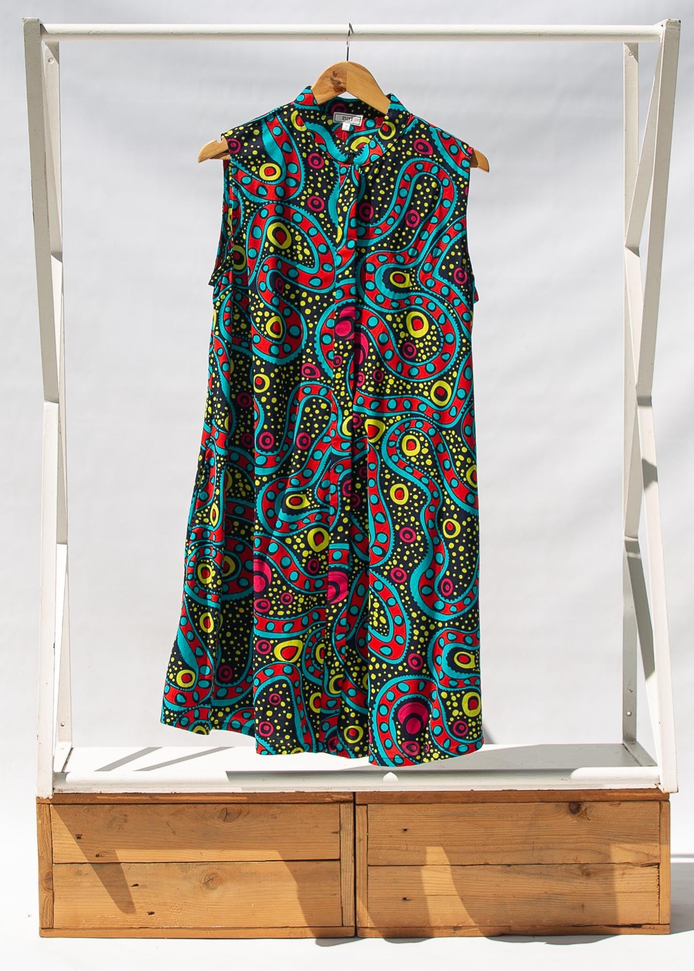 Display of black, yellow, blue, red, pink print dress