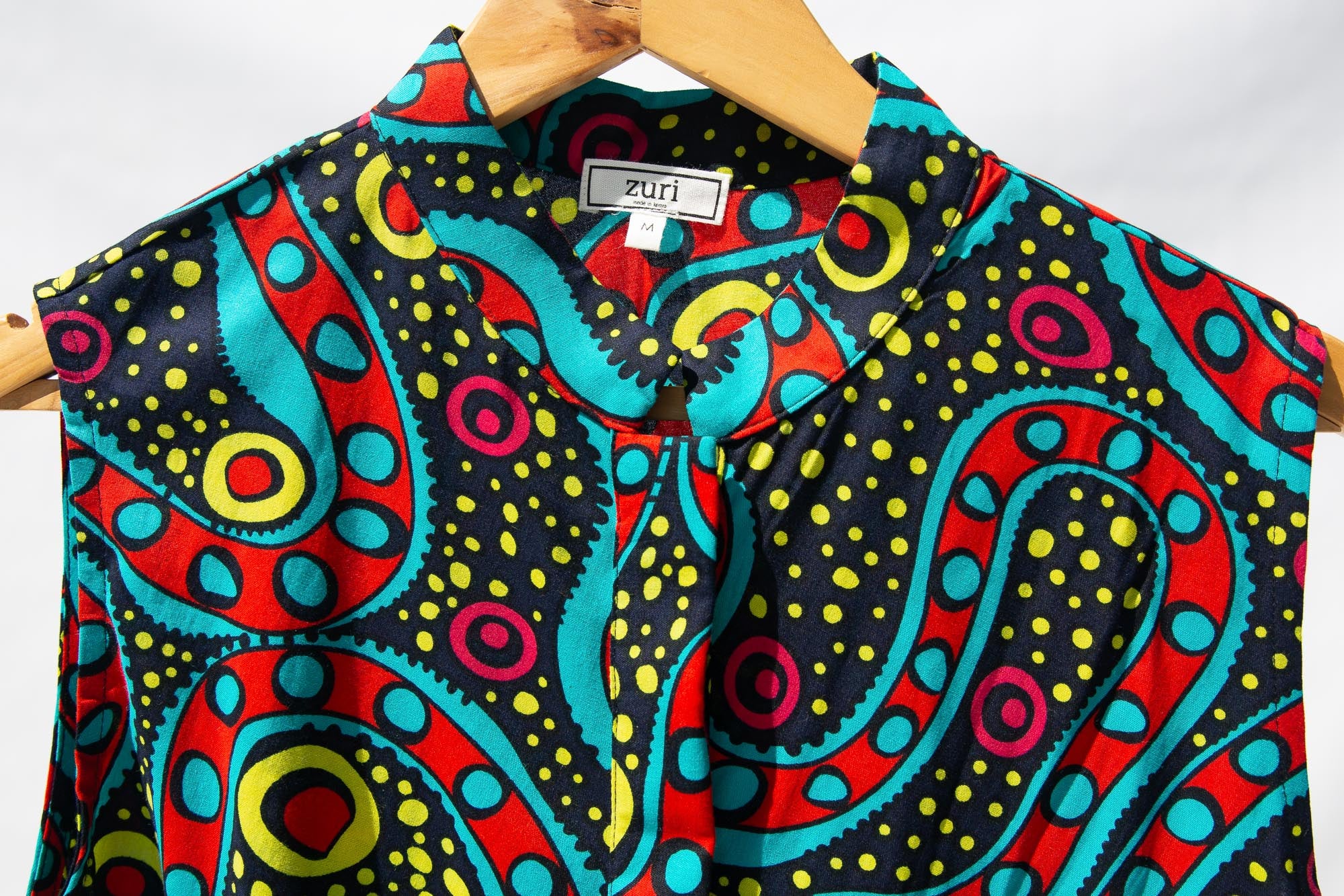 Display of black, yellow, blue, red, pink print dress