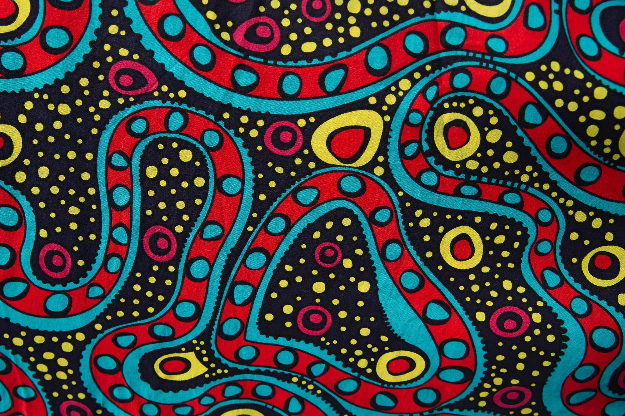 Close up display of black, yellow, blue, red, pink print dress