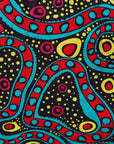 Close up display of black, yellow, blue, red, pink print dress