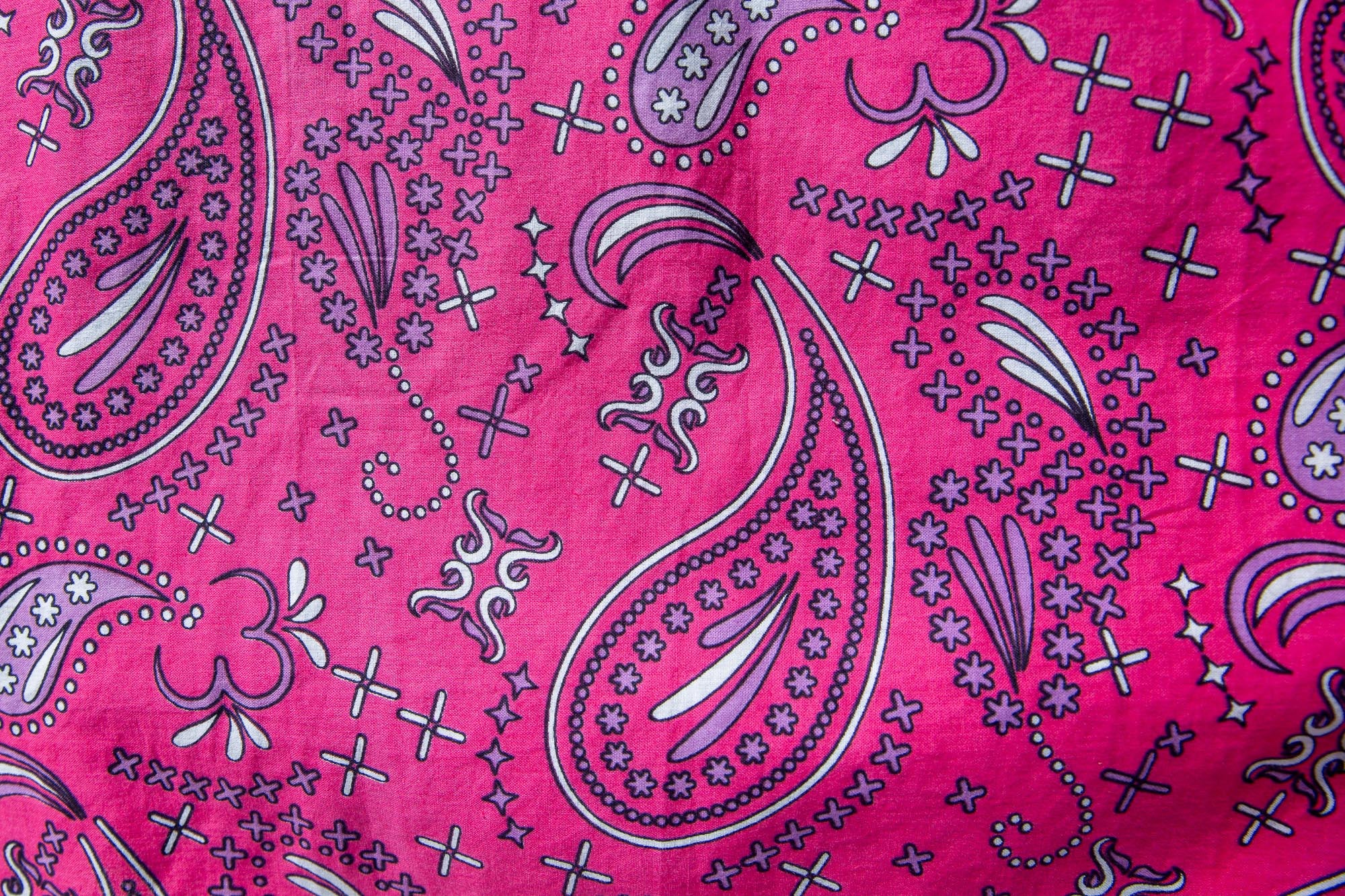 Close up display of black, pink, sky blue, white, purple print shirt
