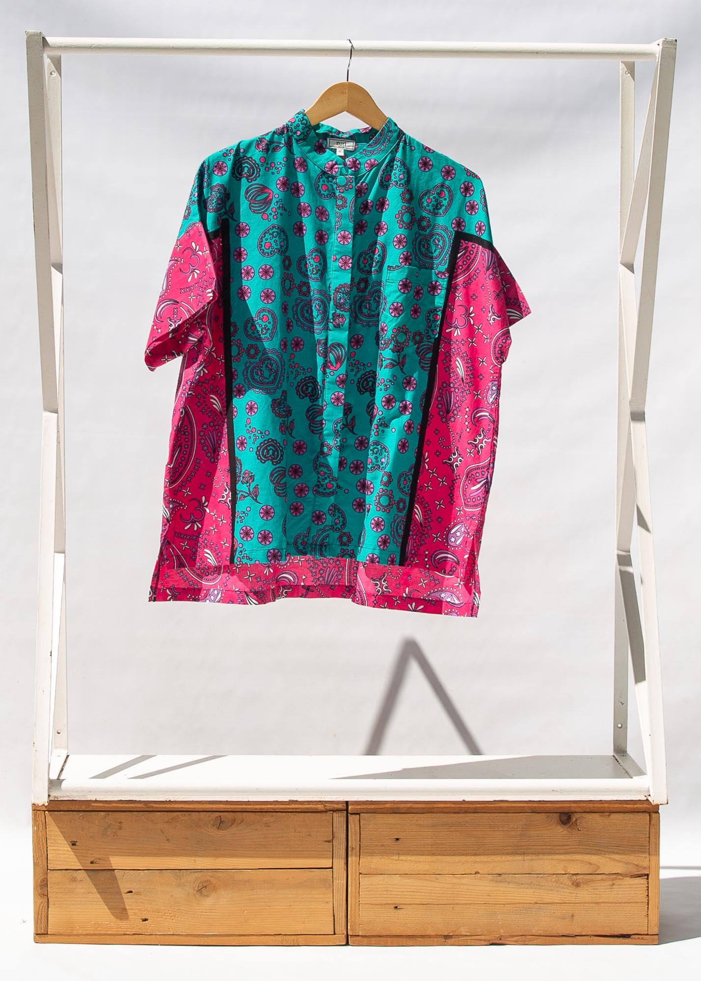 Display of black, pink, sky blue, white, purple print shirt