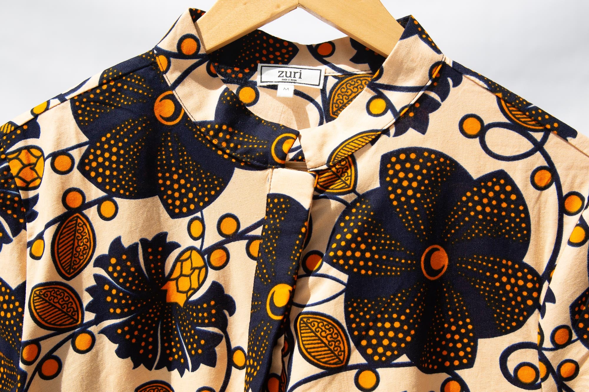 Display of navy, black, off white, yellow flower print dress