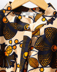 Display of navy, black, off white, yellow flower print dress