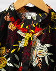 Display of black, white, red, yellow, peach floral print dress