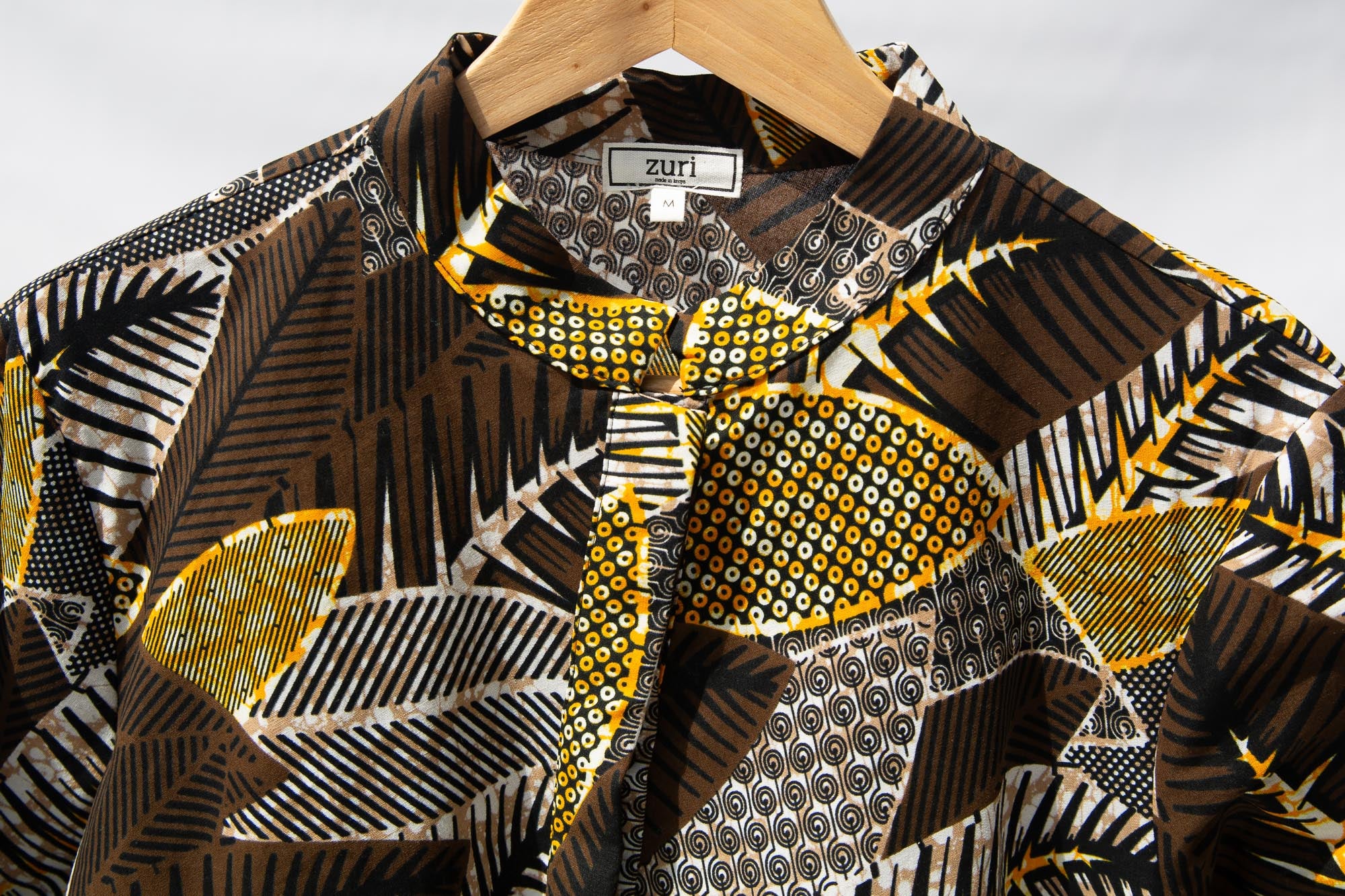 Display of black, brown, yellow, beige print dress