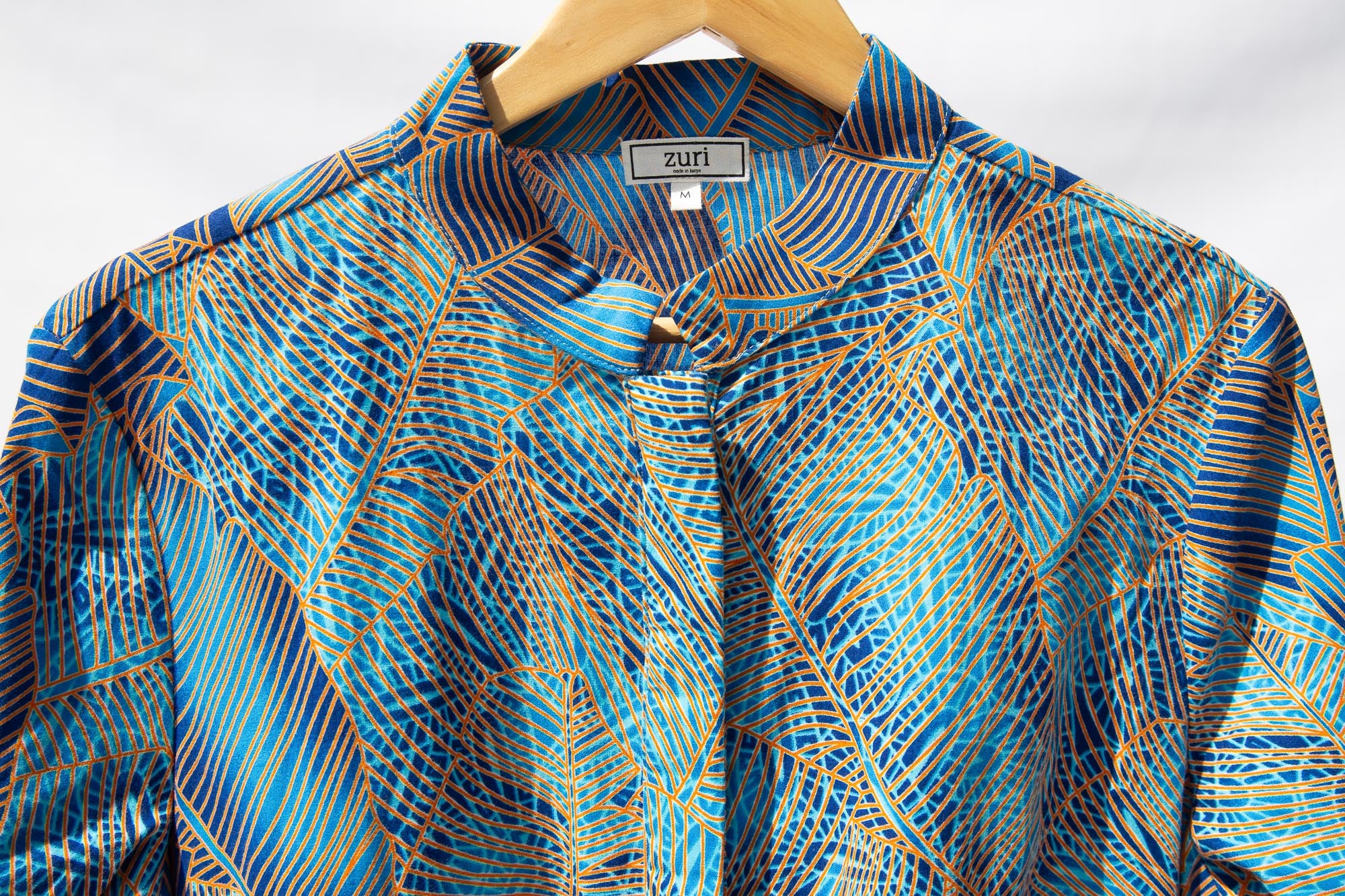Display of sky blue, blue, orange print midi dress