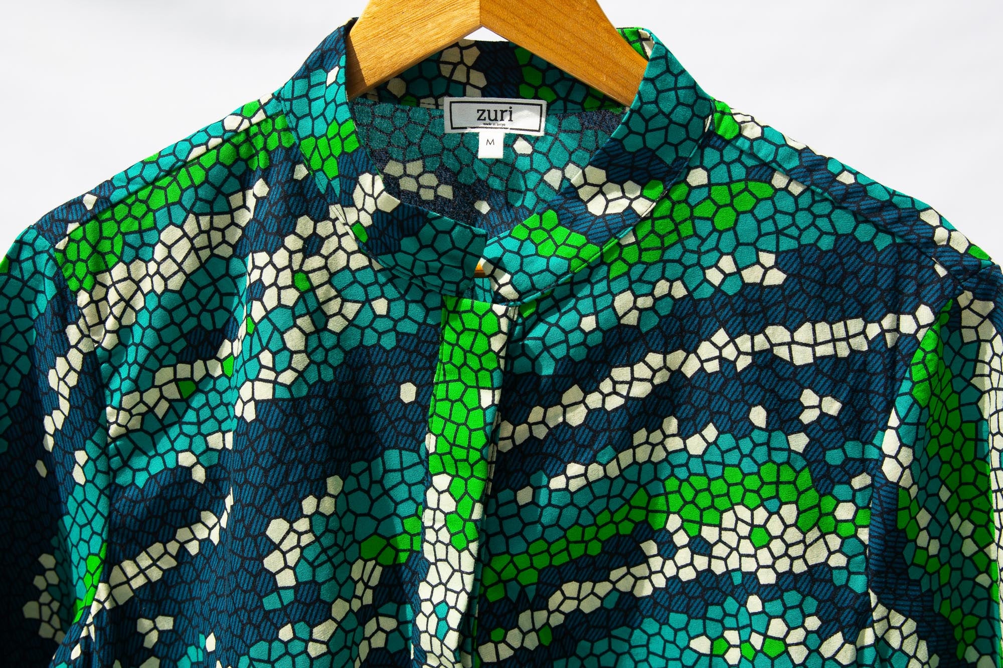 Display of black, green, white, blue and aqua print dress