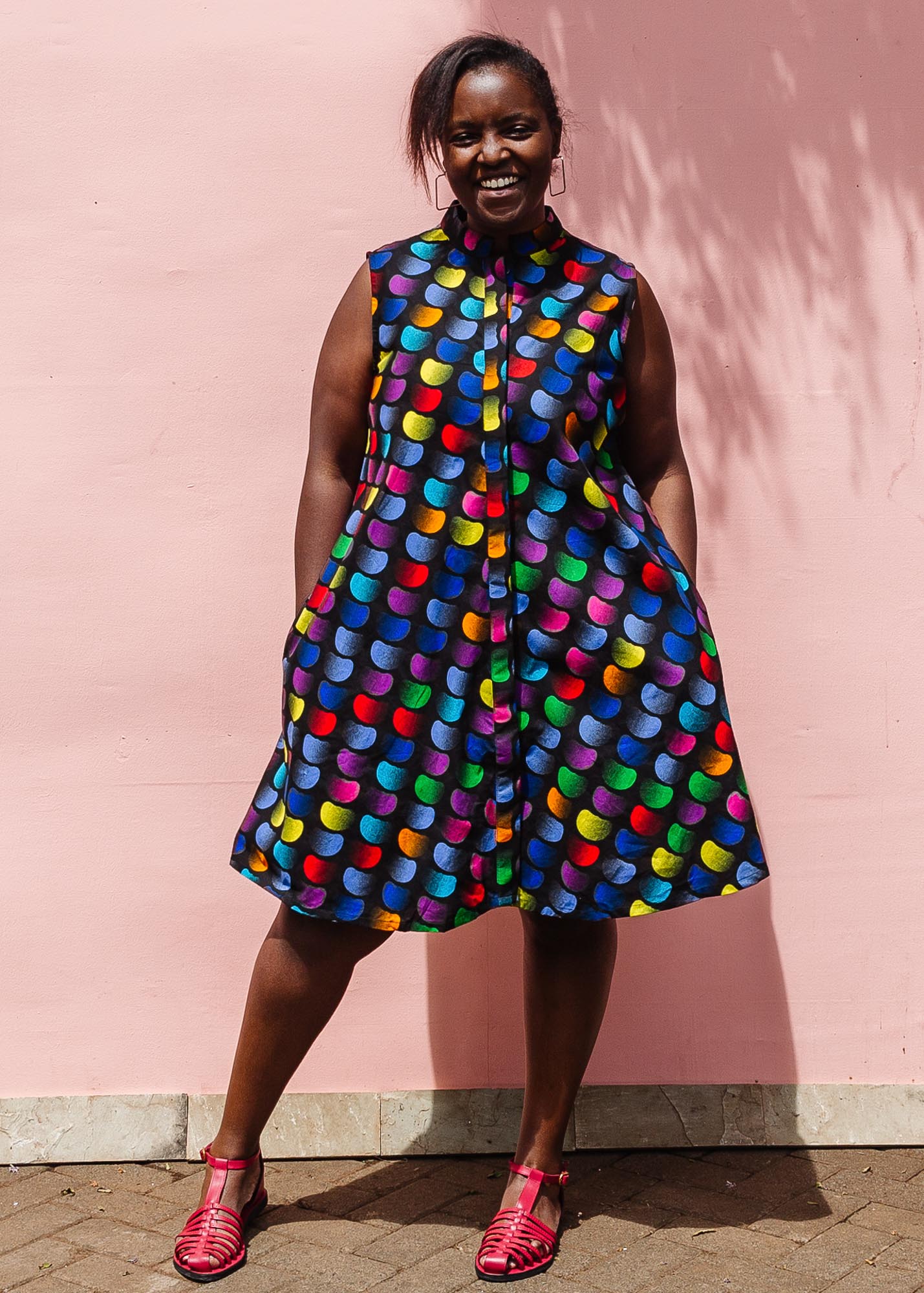 The model is wearing black dress with colorful panel