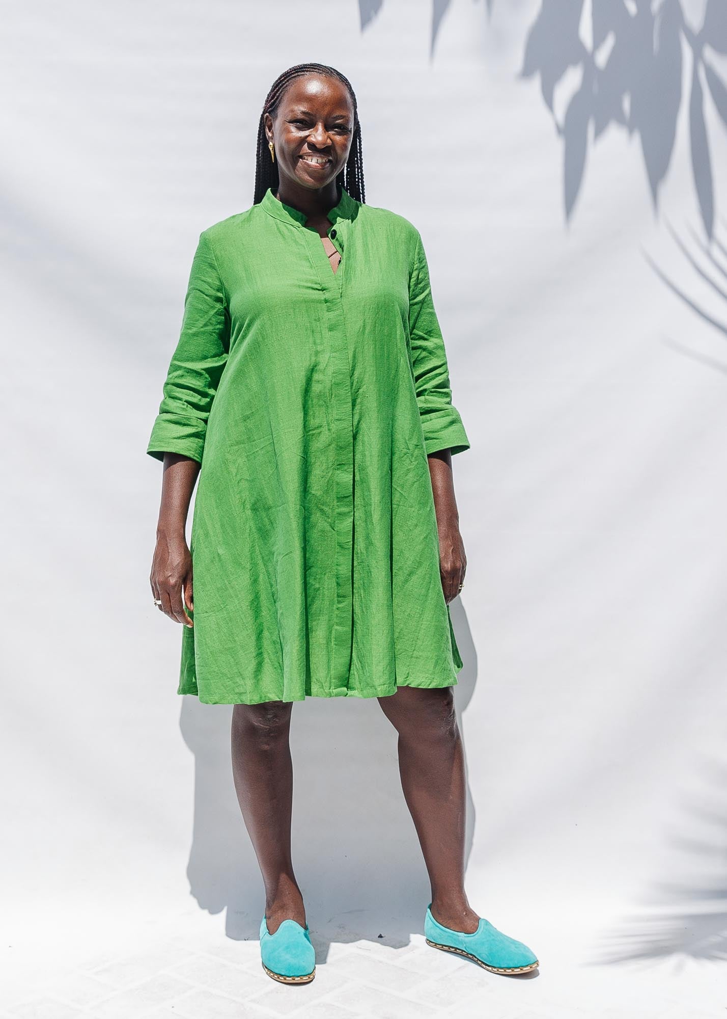 The model is wearing lichen green dress