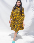 The model is wearing black, yellow print dress