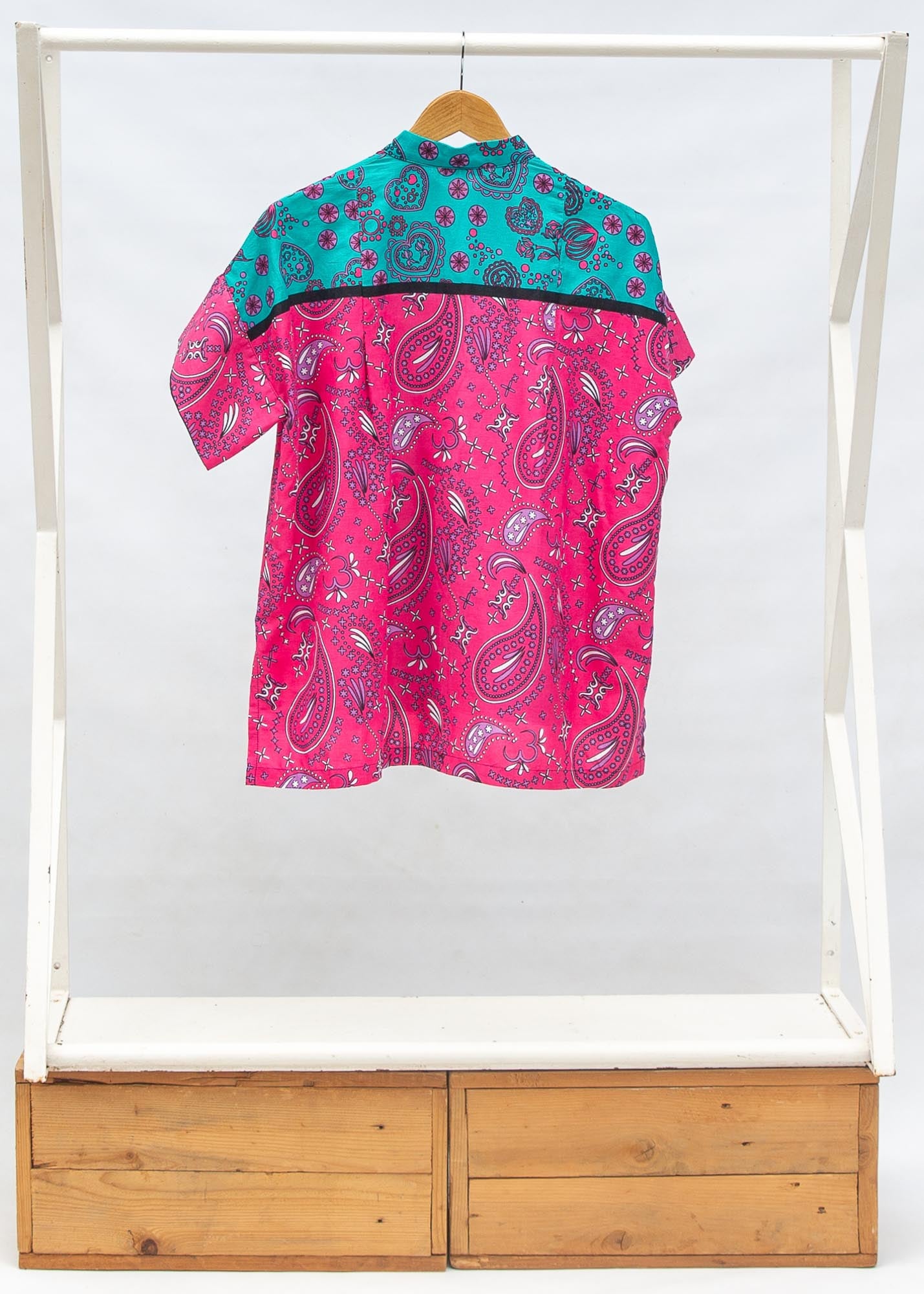 Display of black, pink, sky blue, white, purple print shirt