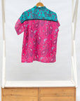 Display of black, pink, sky blue, white, purple print shirt