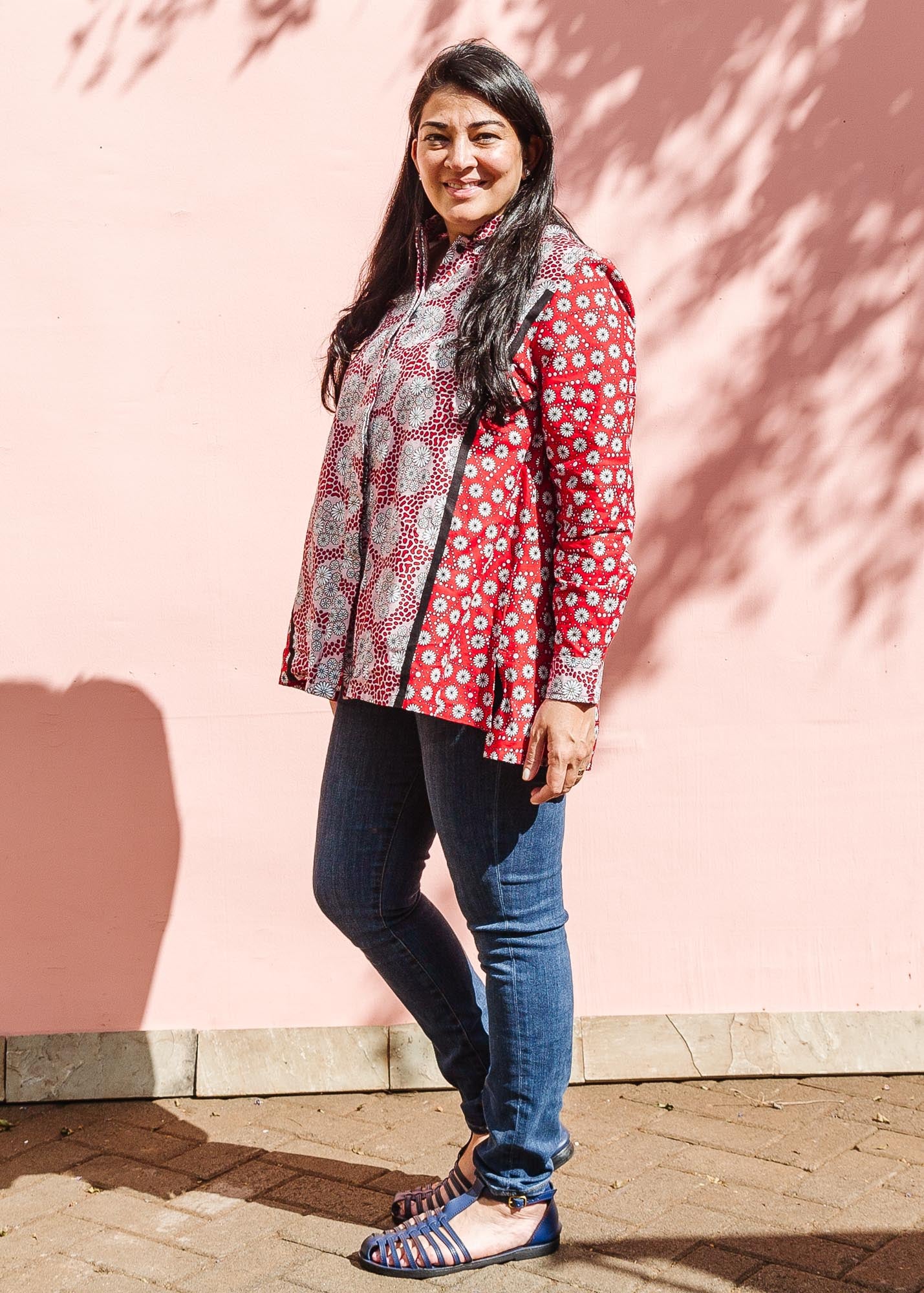The model is wearing red, black, white print shirt