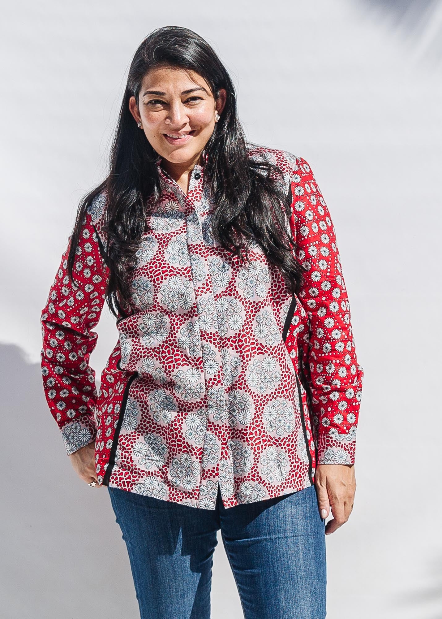 The model is wearing red, black, white print shirt