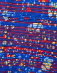 Close up display of a red and blue graphic print sleeveless dress.