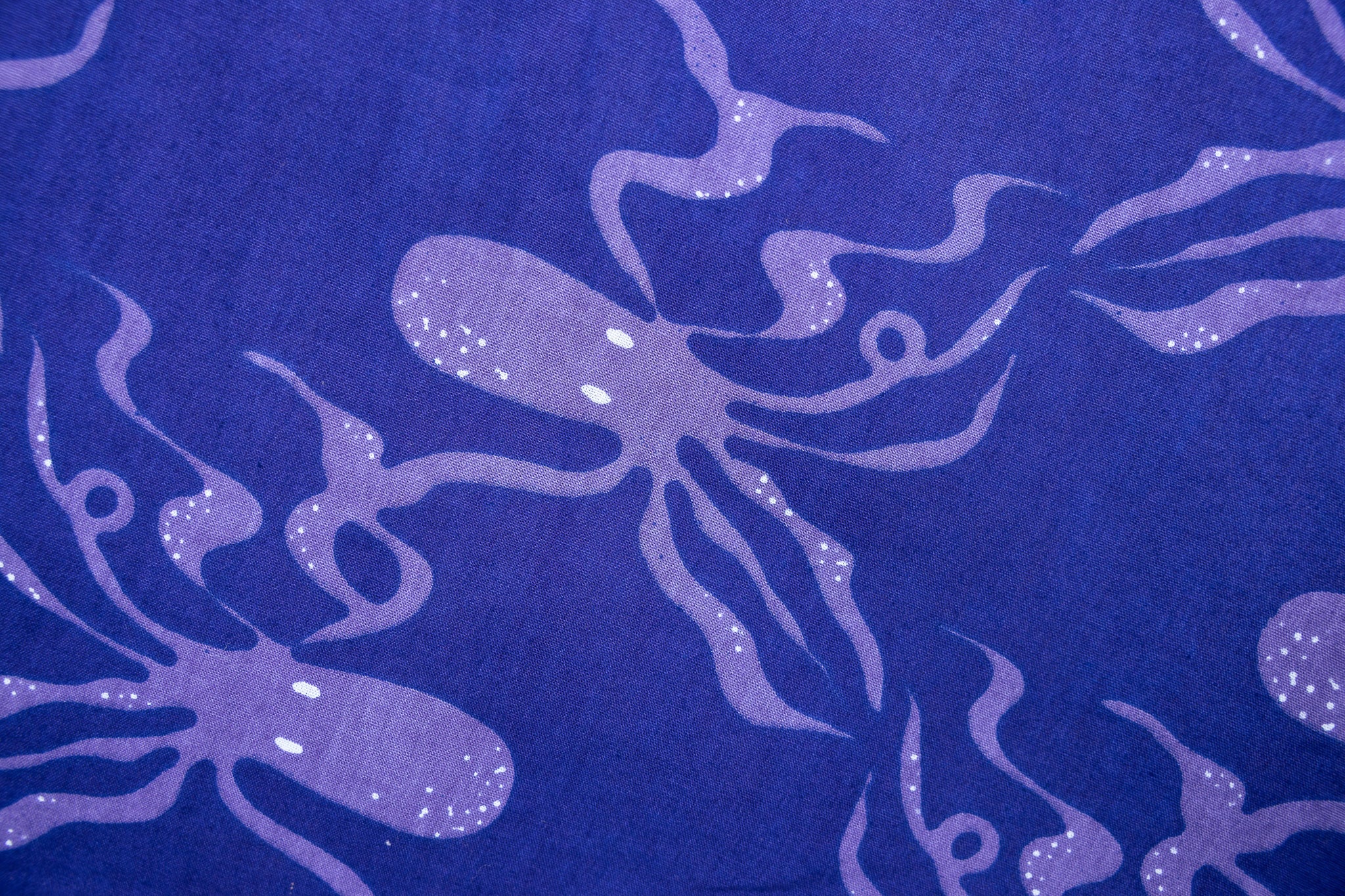 Close up display of purple dress with octopus print.