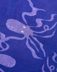 Close up display of purple dress with octopus print.